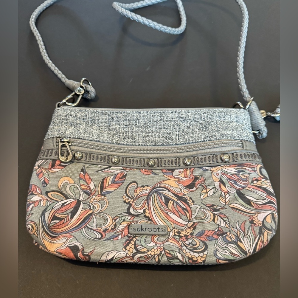 Sakroots Campus Mini cross-body bag in a grey, multi-colored floral pattern
